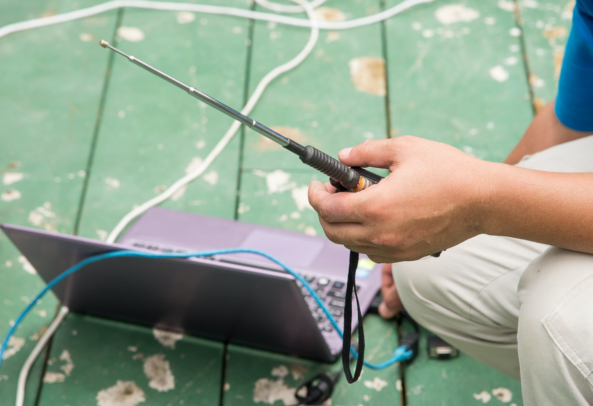 Engineers use radio commands with laptop computer.